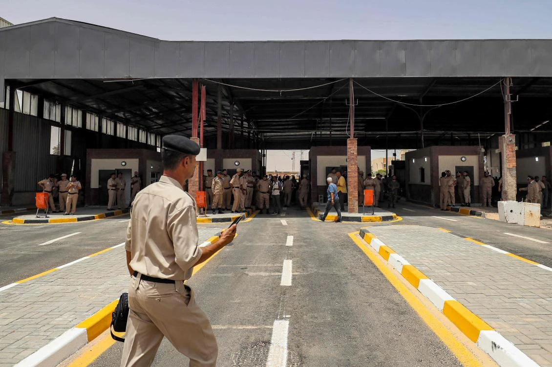 Officials attend the reopening of the Ras Ajdir border crossing between Libya and Tunisia on July 1, 2024. The crossing between the two North African countries was shut since March 19, following what Libyan media said were clashes between armed groups and security forces on the Libyan side. Ras Ajdir, in Tunisia’s south, is a major hub of informal trade between the two nations. (AFP)