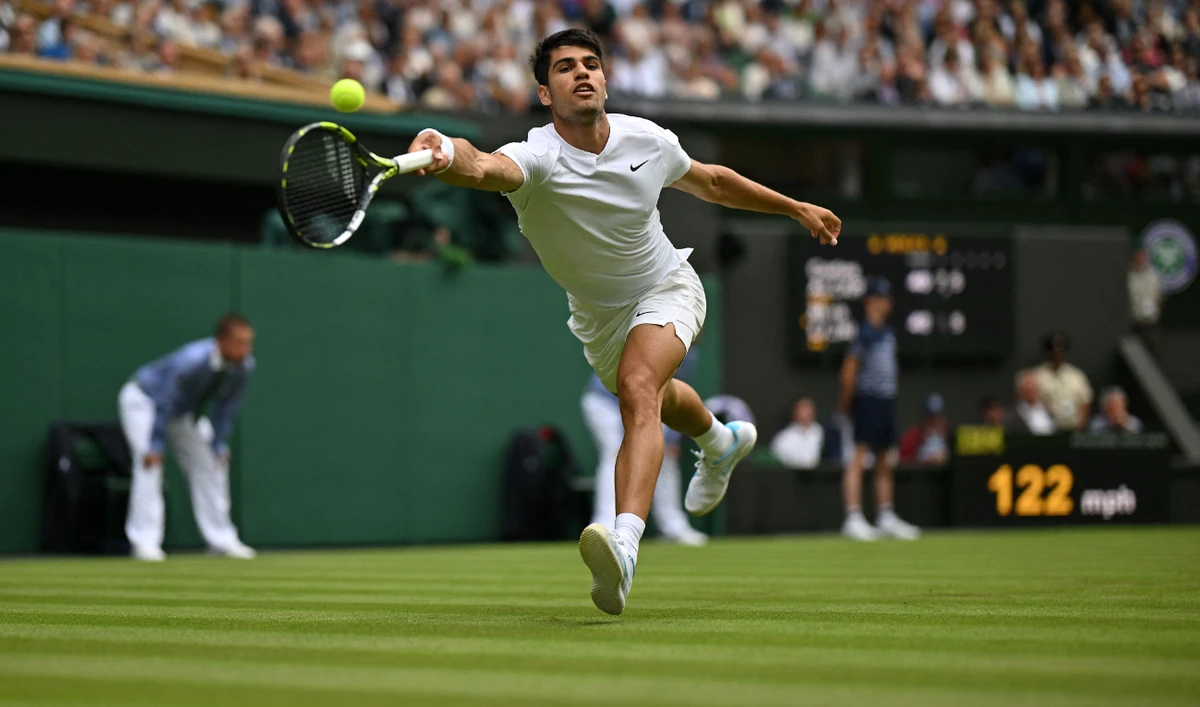 Spain's Carlos Alcaraz returns against Estonia's Mark Lajal during their men's singles tennis match on the first day of the 2024 Wimbledon Championships at The All England Lawn Tennis and Croquet Club on July 1, 2024. (AFP)