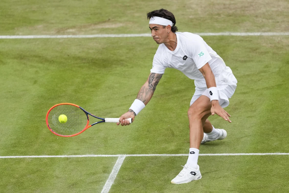 Francisco Comesana of Argentina plays a forehand return to Andrey Rublev of Russia during their first round match at the Wimbledon tennis championships in London on Jul. 2, 2024. (AP)