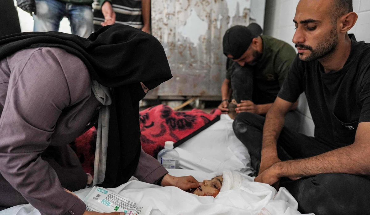 Family members mourn by the body of Islam Tayyim and his son Mohamed, who were killed during overnight Israeli bombardment on their house in Nuseirat in the central Gaza Strip, as they lie at the Aqsa Martyrs hospital in Deir el-Balah on July 2, 2024 amid the ongoing conflict in the Palestinian territory between Israel and Hamas. (AFP)