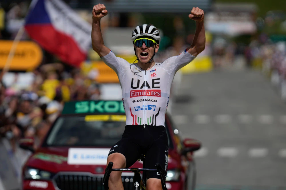 Slovenia's Tadej Pogacar celebrates as he crosses the finish line to win the fourth stage of the Tour de France cycling race over 139.6 kilometers (86.7 miles) with start in Pinerolo, Italy and finish in Valloire, France, Tuesday. (AP)
