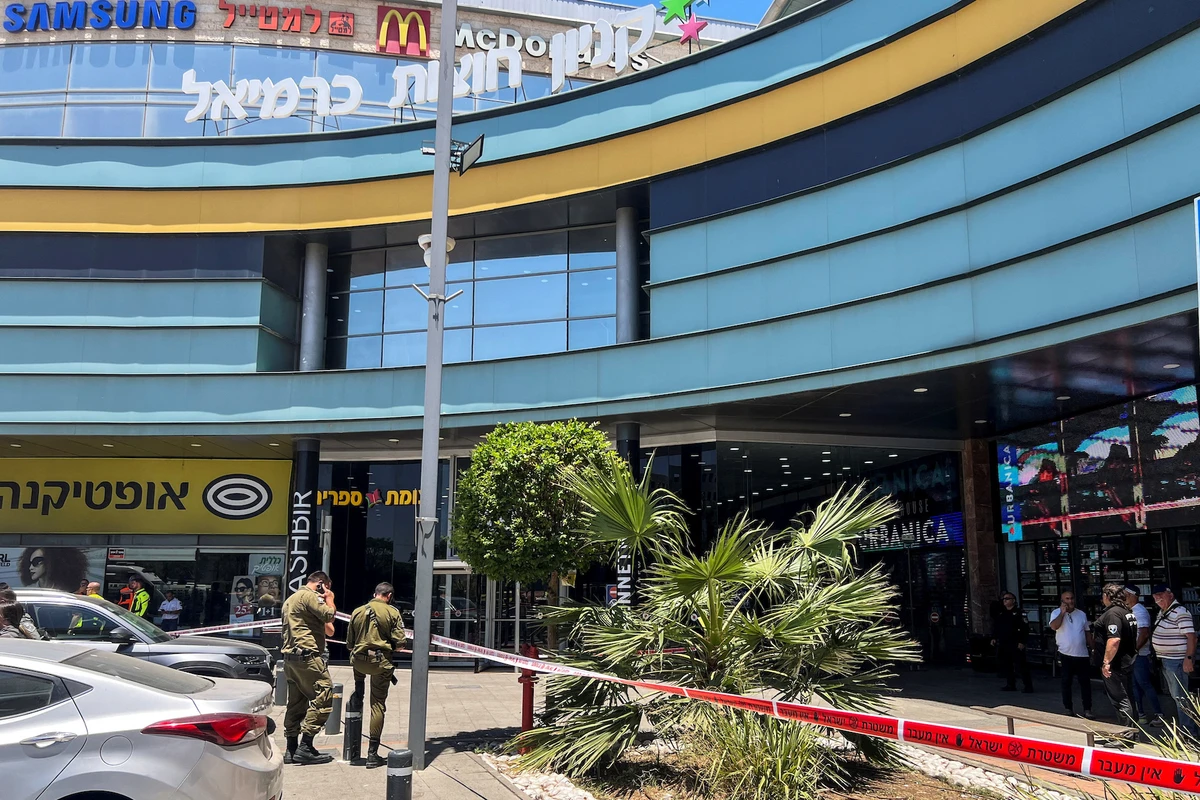 People gather outside a shopping mall following a stabbing attack in Karmiel, northern Israel July 3 2024. (Reuters)