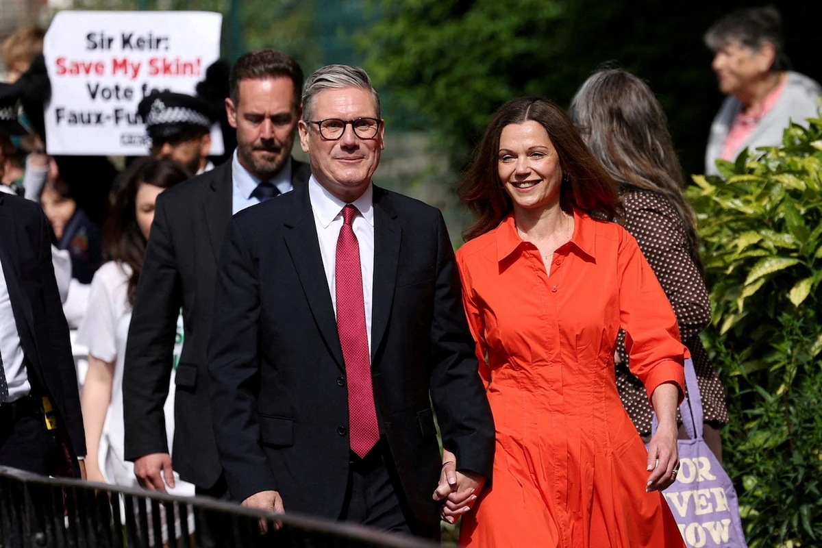 Britain’s opposition Labour Party leader Keir Starmer and his wife Victoria Starmer walk outside a polling station during the general election in London, Britain, July 4, 2024. (Reuters)