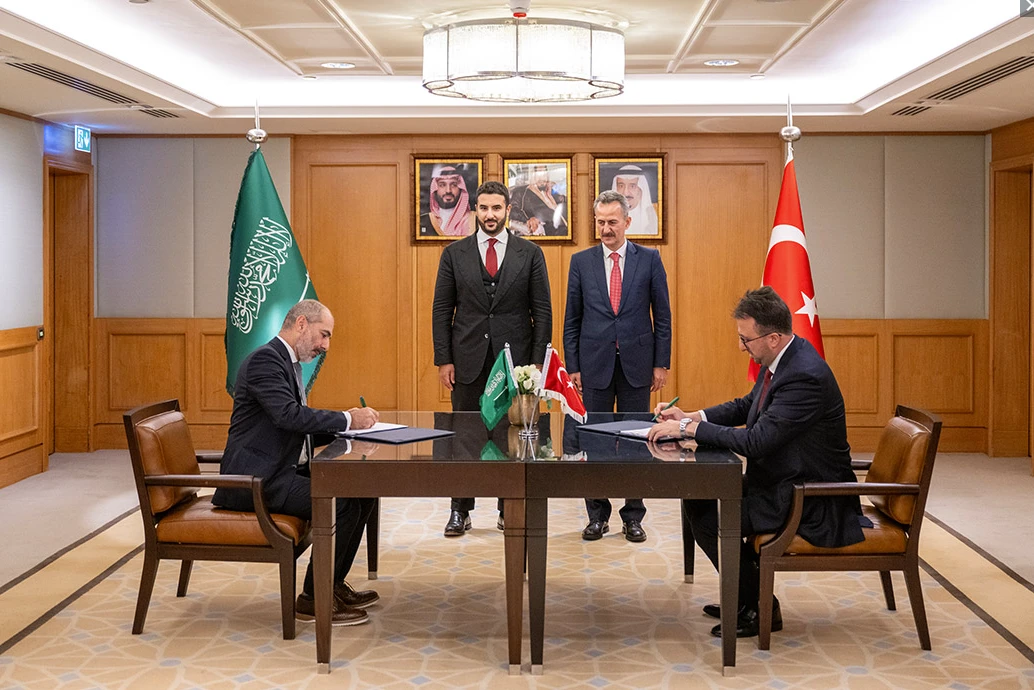 Minister of Defense Prince Khalid bin Salman bin Abdulaziz watches on as the deals are signed. SAMI