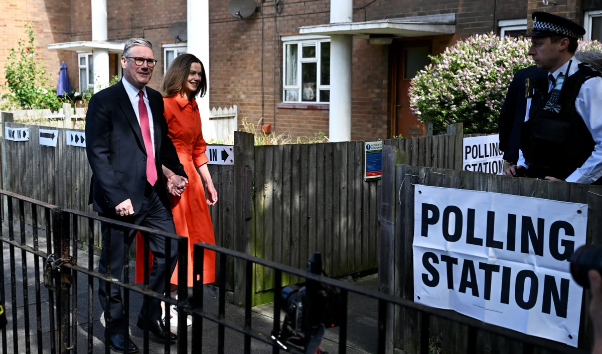 Britain's opposition Labour Party leader Keir Starmer and his wife Victoria arrive to cast their votes at a polling station in London on July 4, 2024 as Britain holds a general election. (AFP)