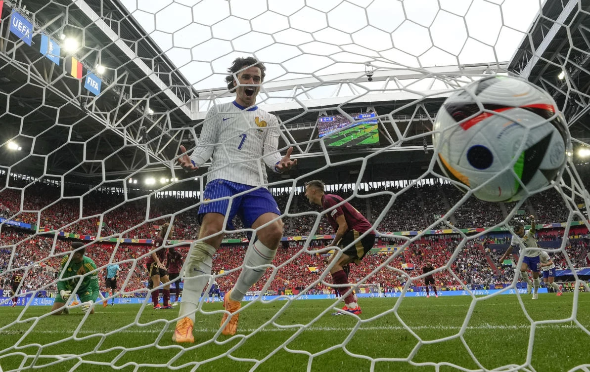 Antoine Griezmann of France celebrates in the Belgium goal after Randal Kolo Muani shot at goal to cause Belgium’s Jan Vertonghen to score an own goal during their round of sixteen match at the Euro 2024 in Duesseldorf on Jul. 1, 2024. (AP)