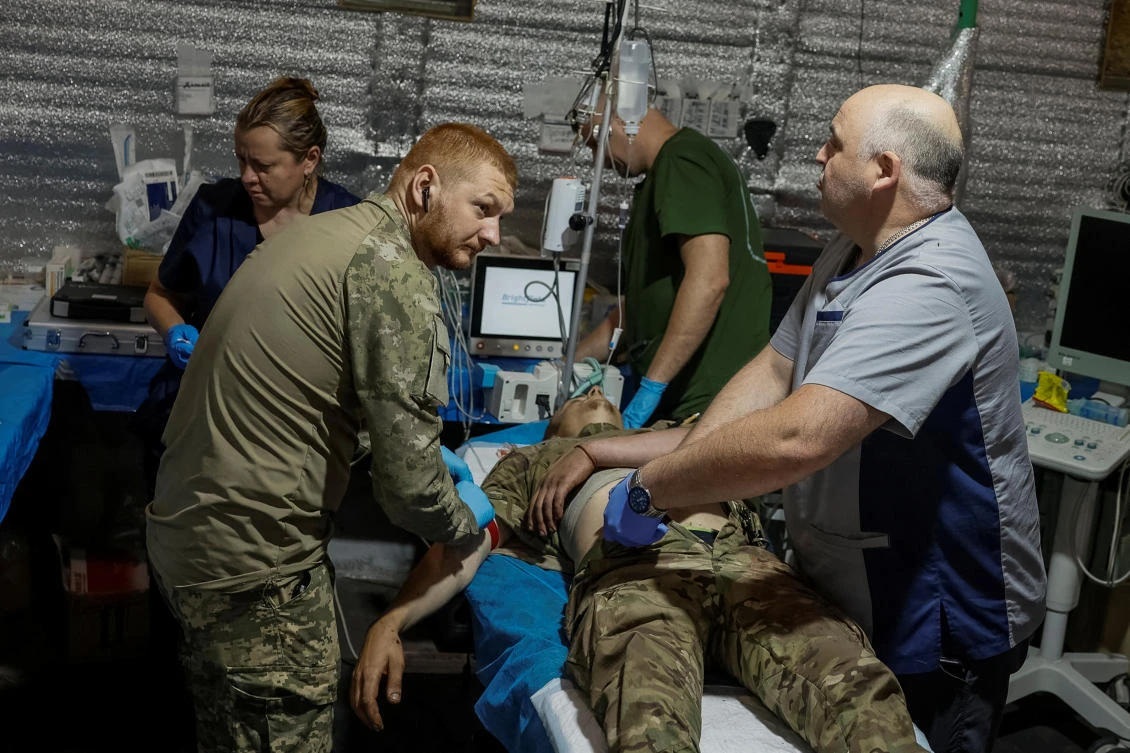 Medics help a wounded Ukrainian serviceman inside a medical stabilization point of the 5th Separate Assault Kyiv Brigade near the town of Chasiv Yar, in Donetsk region, on Jul. 1, 2024. (Reuters)