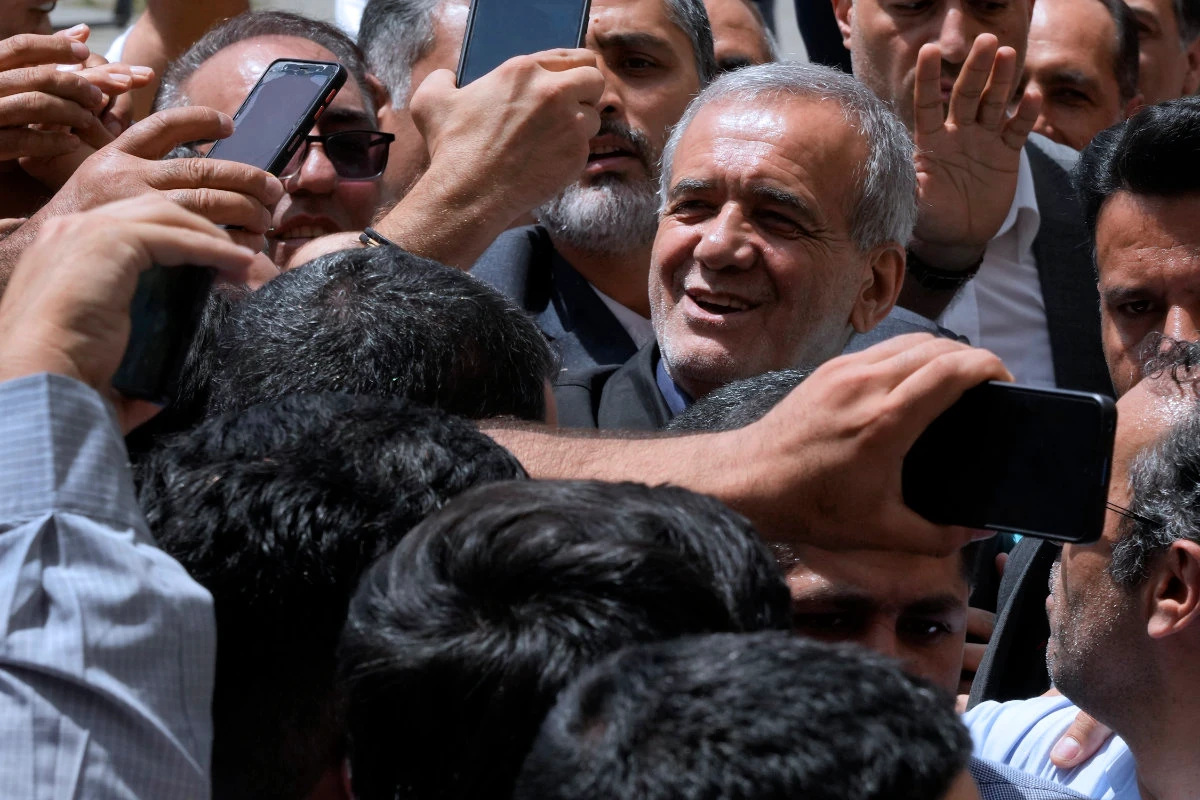 Reformist candidate for the Iran's presidential election Masoud Pezeshkian is greeted by his supporters as he arrives to vote at a polling station in Shahr-e-Qods near Tehran, Iran, on July 5, 2024. (AP)