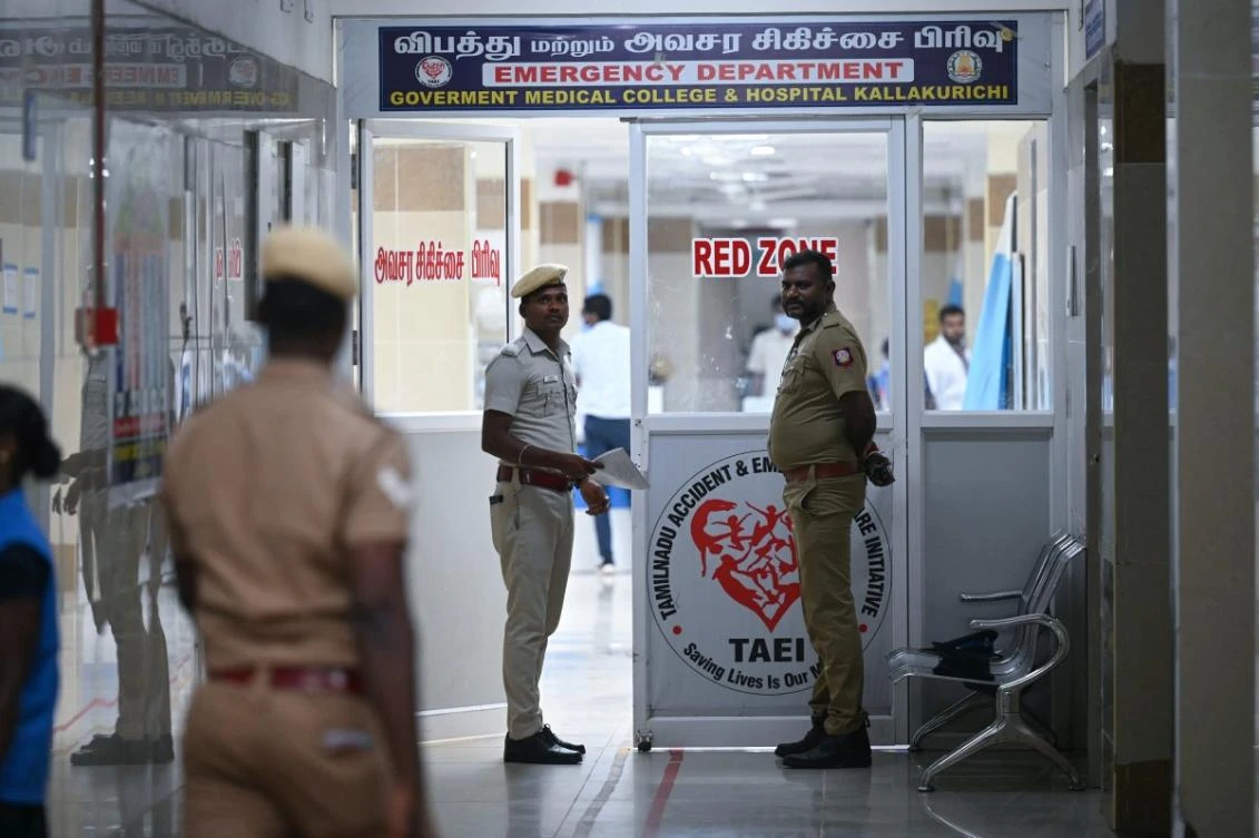 Police stand guard in front of a hospital ward where patients who consumed toxic illegal alcohol were admitted in Kallakurichi district of India's Tamil Nadu state on June 23, 2024. (AFP)