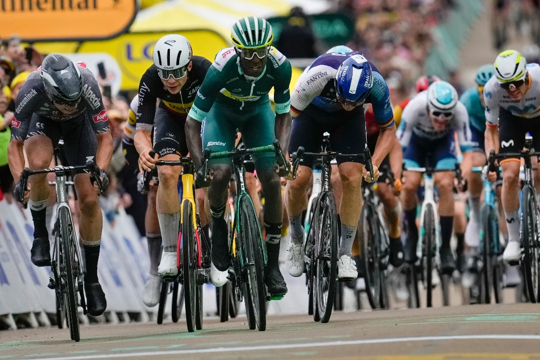 Eritrea's Biniam Girmay, wearing the best sprinter's green jersey, crosses the finish line ahead of 2nd place Belgium's Jasper Philipsen, left, 3rd place Belgium's Arnaud de Lie, second left, and Germany's Pascal Ackermann, center right, to win the 8th stage of the Tour de France. (AP)