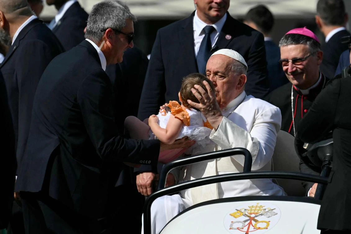 Pope Francis blesses a baby as he arrives to lead a mass during a pastoral visit on the occasion of the 50th Social Week of Italian Catholics, on July 7, 2024 at Piazza dell'Unita in Trieste. (File/AFP)