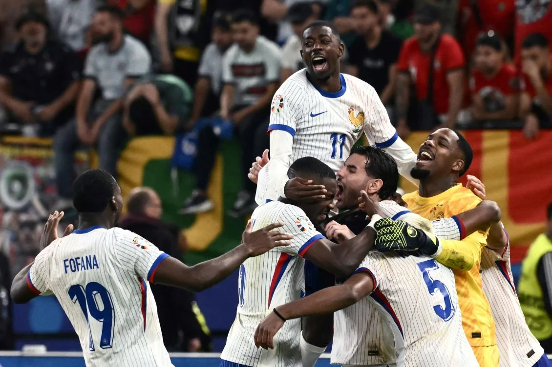 French players celebrate after winning the UEFA Euro 2024 quarter-final football match between Portugal and France at the Volksparkstadion in Hamburg on July 5, 2024. (AFP)