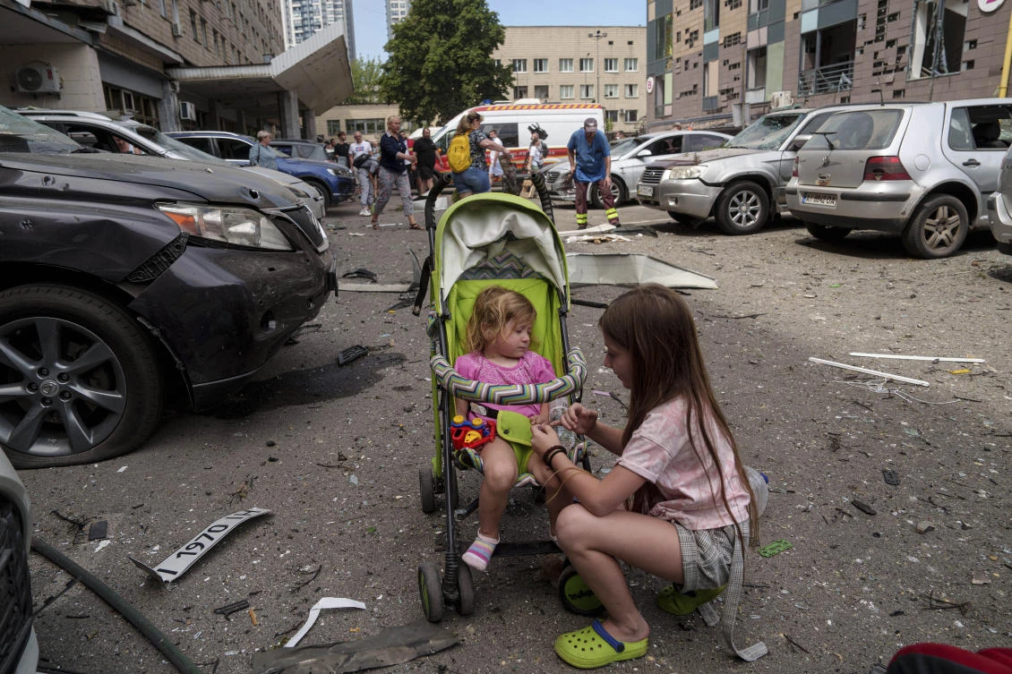 Children wait near the site of Okhmatdyt children’s hospital hit by Russian missiles, in Kyiv, Ukraine, Monday, July 8, 2024. Russian missiles have killed several people and struck a children’s hospital in the Ukrainian capital, Kyiv, authorities say. (AP)