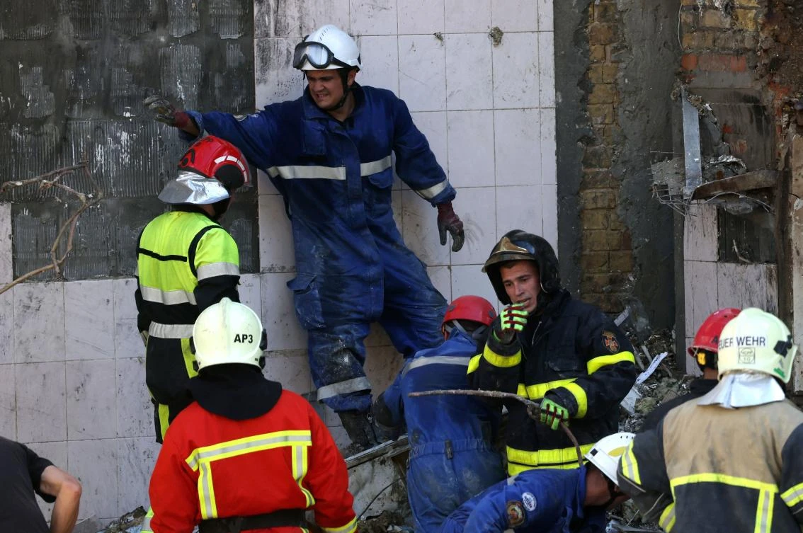 Emergency and rescue personnel operate and clear the rubble of the destroyed building of Ohmatdyt Children’s Hospital, a day after a missile attack in Kyiv on Jul. 9, 2024. (AFP)
