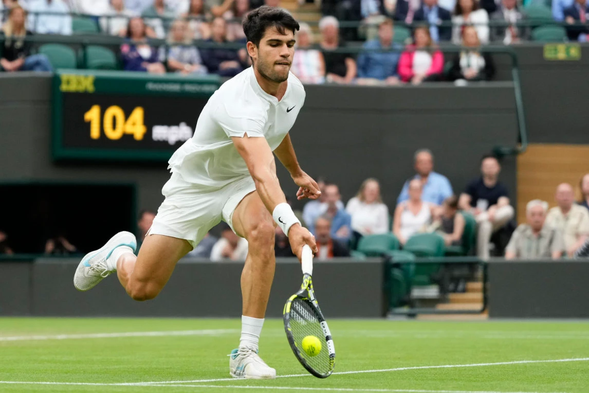 Carlos Alcaraz of Spain plays a forehand return to Tommy Paul of the US during their quarterfinal match at the Wimbledon tennis championships in London Tuesday. (AP)