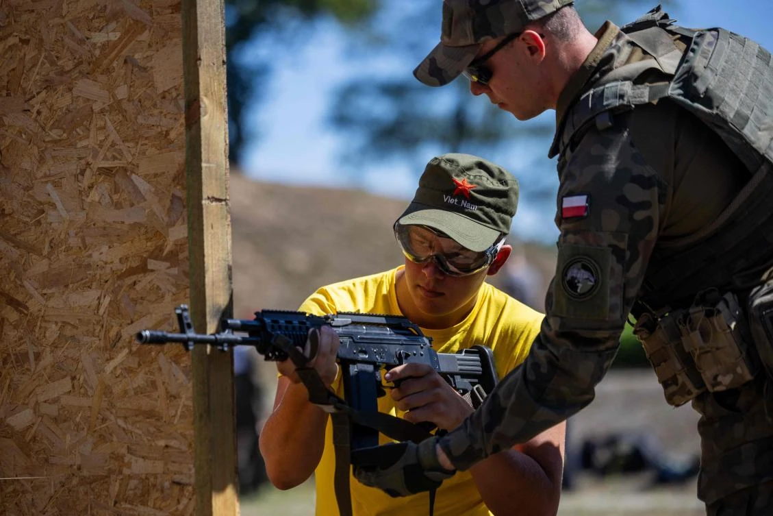 An army instructor explains how to shoot with ASG rifles during a military training day which is part of the Polish Army’s summer program at the military base of the 25th Air Cavalry Brigade in Tomaszów Mazowiecki, Poland, on Jul. 6, 2024. (AFP)