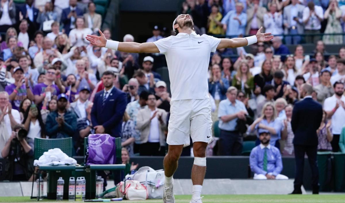 Lorenzo Musetti of Italy celebrates after defeating Taylor Fritz of the US in their quarterfinal match at the Wimbledon tennis championships in London Wednesday. (AP)