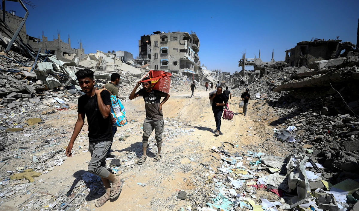 Palestinians make their way as they inspect the damage, after Israeli forces withdrew from Shejaiya neighborhood, following a ground operation, amid Israel-Hamas conflict, in the eastern part of Gaza City on July 10, 2024. (REUTERS)