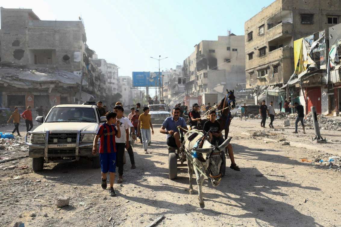 Palestinians look on near damages, after Israeli forces withdrew from a part of Gaza City, following a ground operation, amid the Israel-Hamas conflict, in Gaza City, July 12, 2024. (REUTERS)