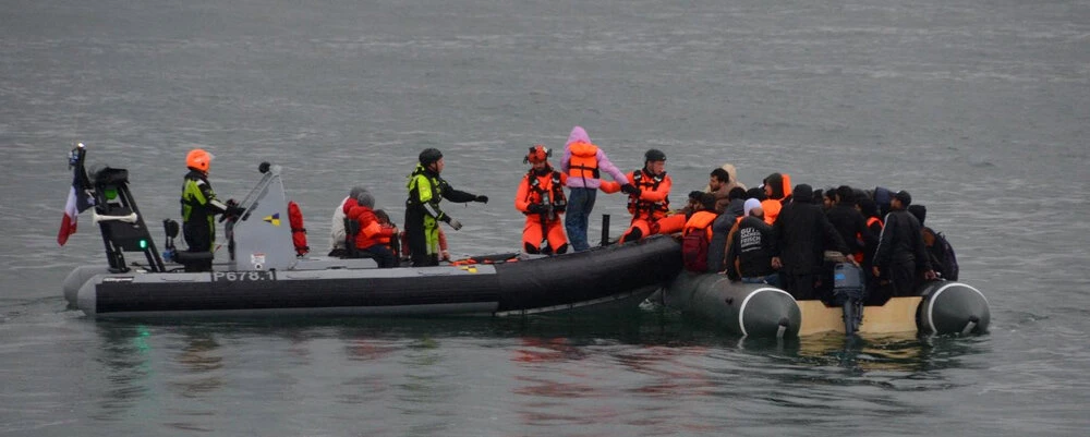 This handout photograph released by France’s Prefecture Maritime on July 12, 2024, shows rescuers assisting migrants from an inflatable dinghy off the coast of Boulougne-sur-Mer, northern France, after four migrants drowned overnight in The English Channel. (AFP)