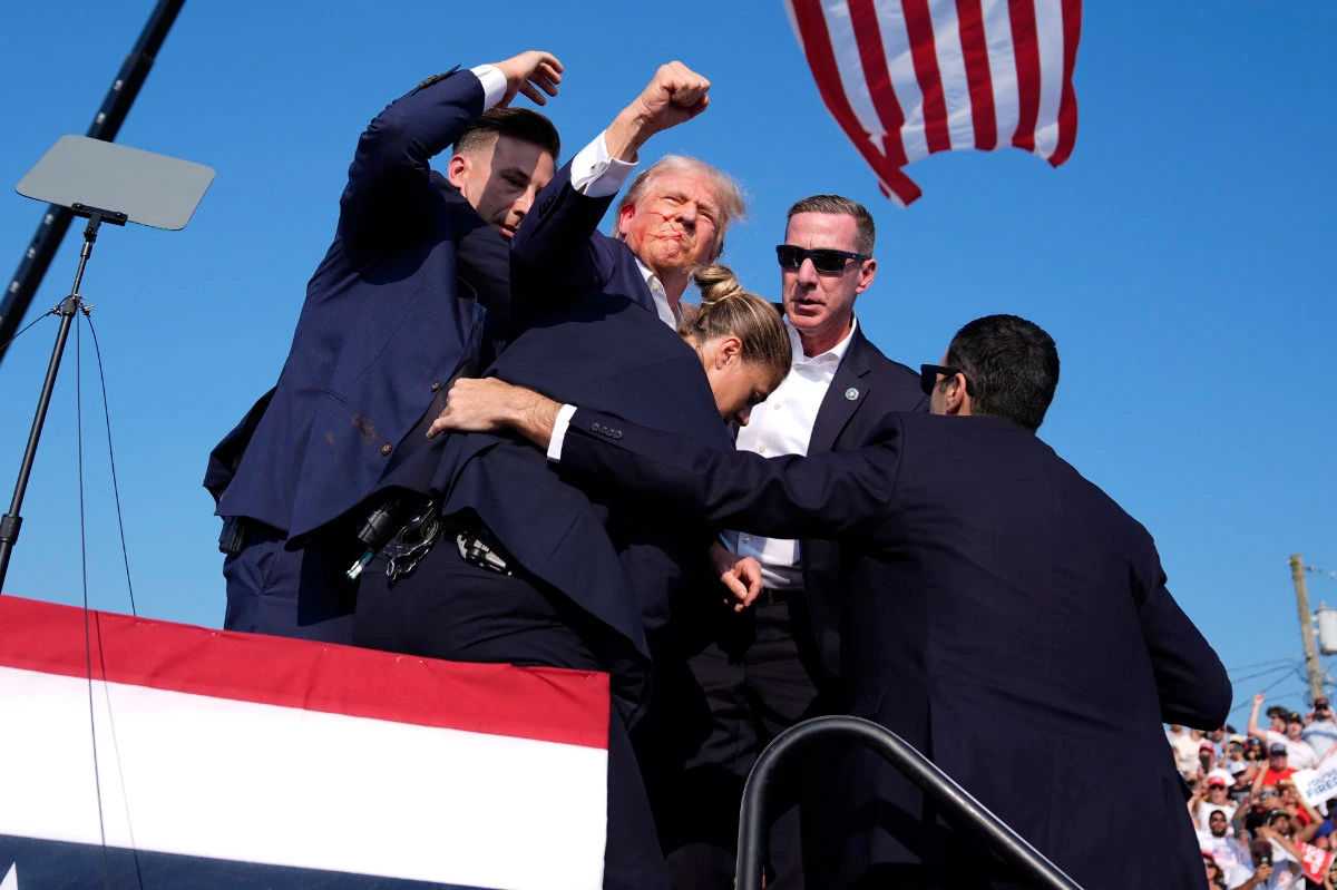 With his fist raised in a salute of defiance, a wounded Trump entered the iconography of American history in Butler, Pennsylvania. (Evan Vucci/AP)