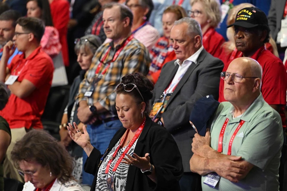 Attendees pray during the first day of the 2024 Republican National Convention at the Fiserv Forum in Milwaukee. (AFP)