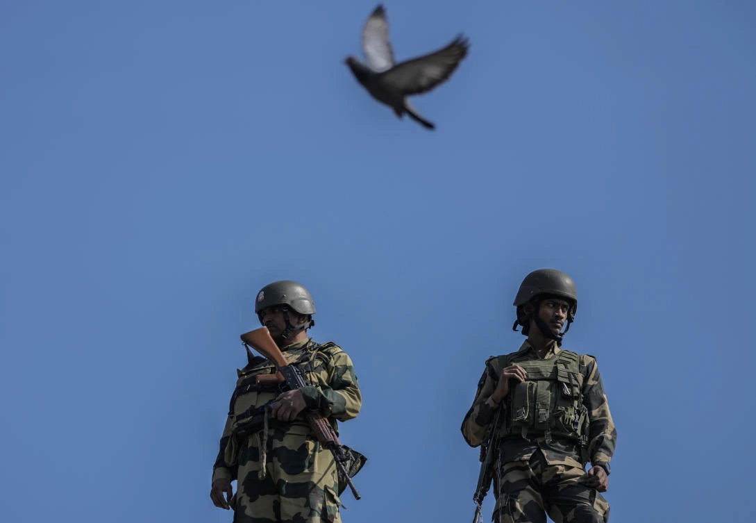 Indian paramilitary soldiers guard as a pigeon flies over them during a Muharram procession in Srinagar, Indian controlled Kashmir, Monday, July 15, 2024. (AP)