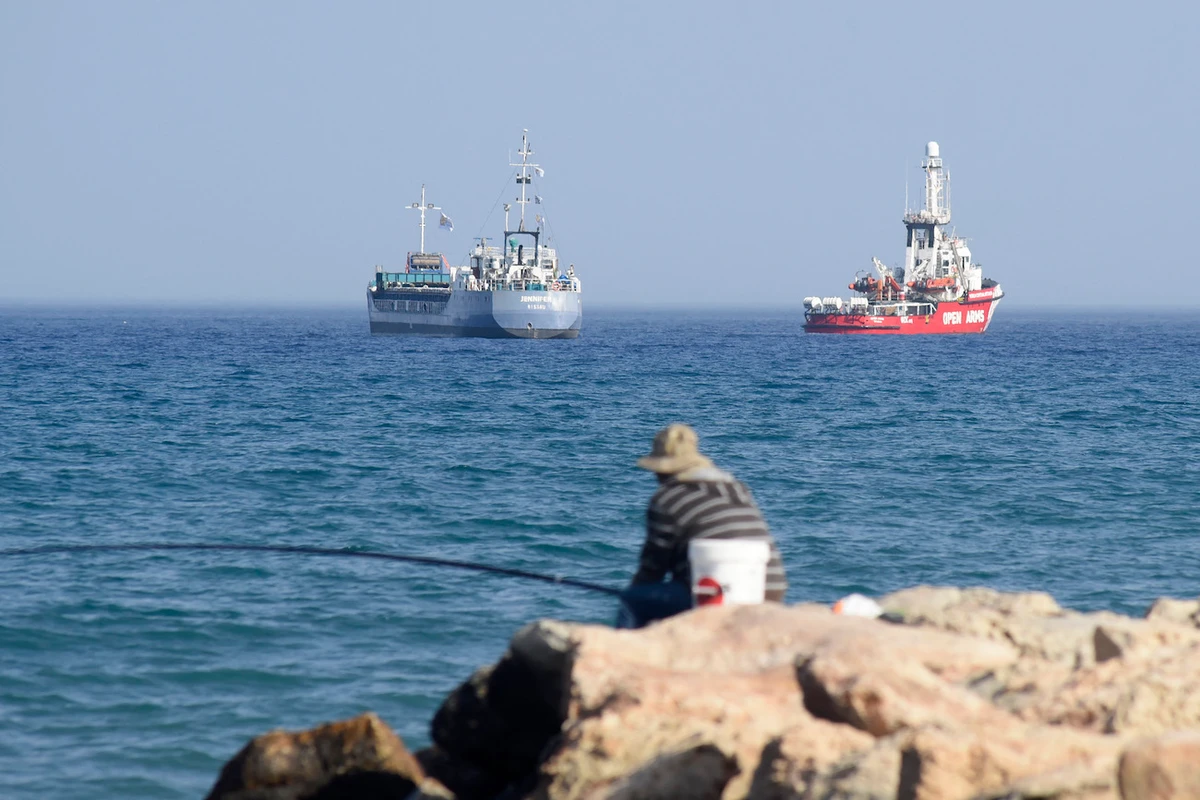 An Open Arms ship and ship Jennifer, of the World Central Kitchen carrying food aid for the Gaza Strip, prepare to set sail close to the port of Larnaca in Cyprus on March 30, 2024. (File/AFP)