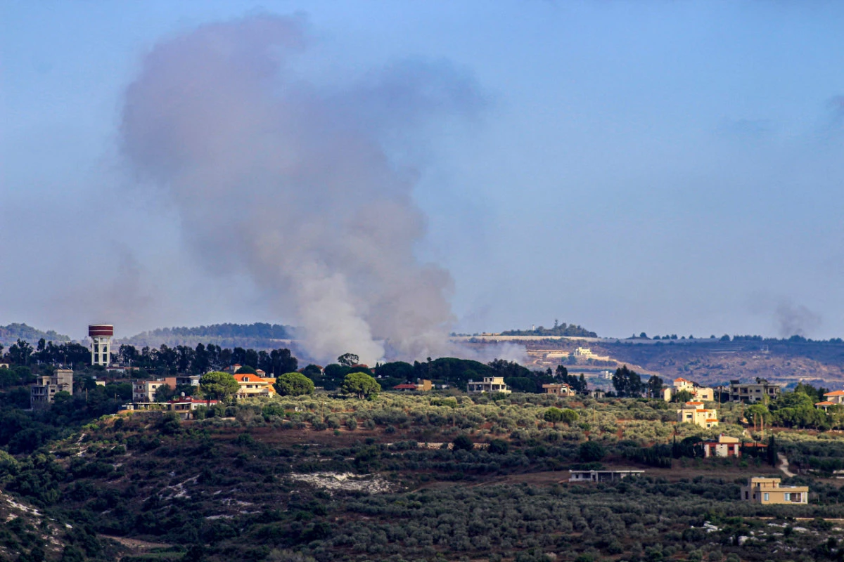 Smoke billows from a site targeted by Israeli shelling in the southern Lebanese village of Boustane near the border with Israel on July 18, 2024. (AFP)