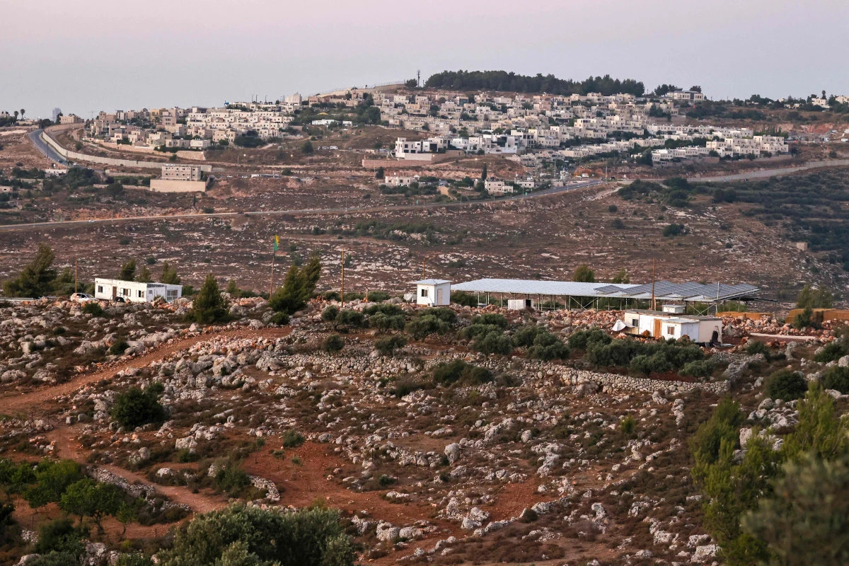 This picture shows a new outpost of Israeli settlers (center), backdropped by Har Gilo, as viewed from the Palestinian village of Battir, a UNESCO heritage site in the occupied West Bank south of Jerusalem, on July 8, 2024. Young Israeli settlers are hammering out a new, illegal outpost in the UNESCO-protected zone. (AFP)