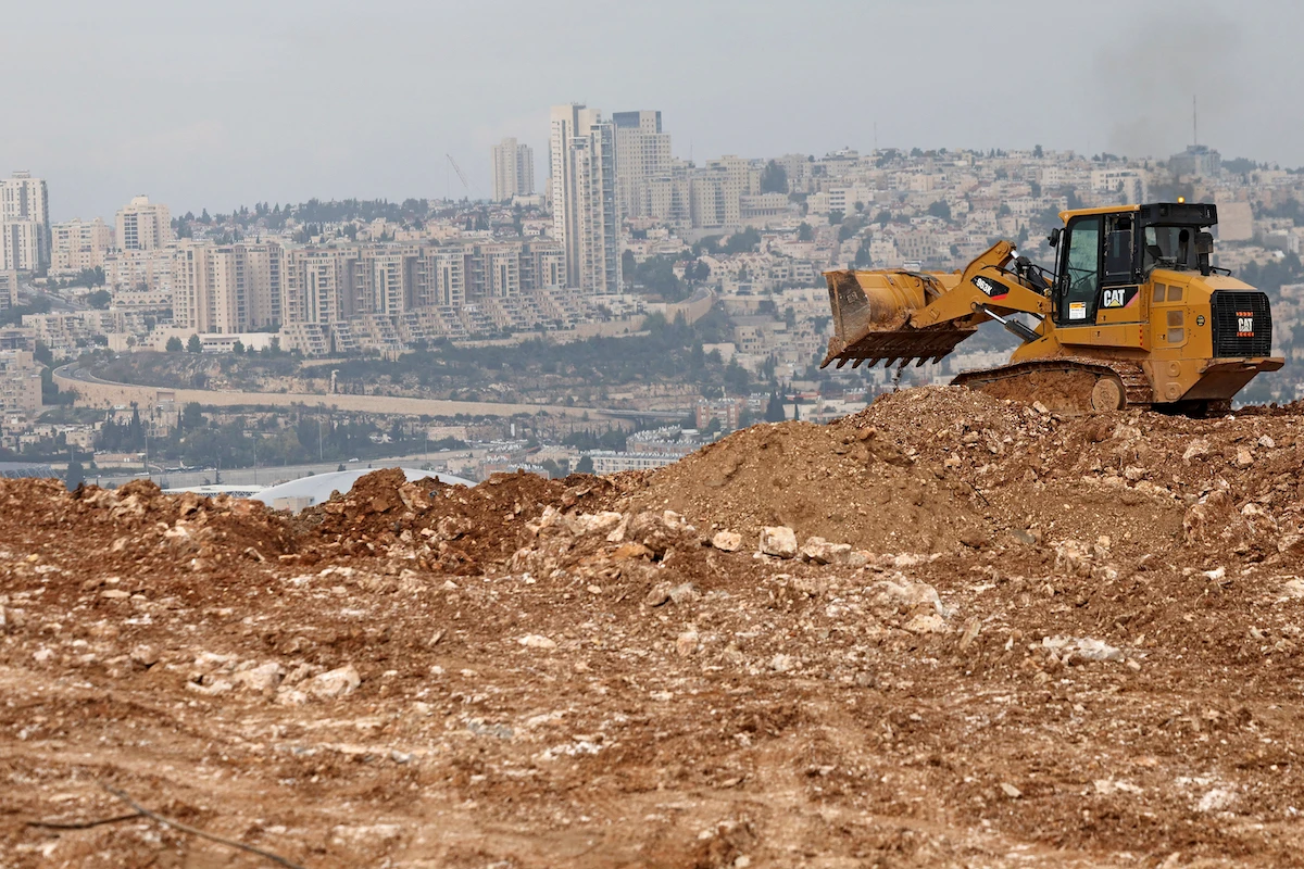 A bulldozer operates at a construction site in Givat HaMatos, an Israeli settlement suburb of annexed east Jerusalem on December 7, 2023. (File/AFP)