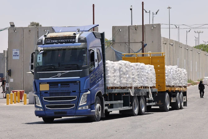 A truck carrying humanitarian aid for the Gaza Strip drives at the Kerem Shalom (Karm Abu Salem) border crossing between southern Israel and Gaza. (File/AFP)