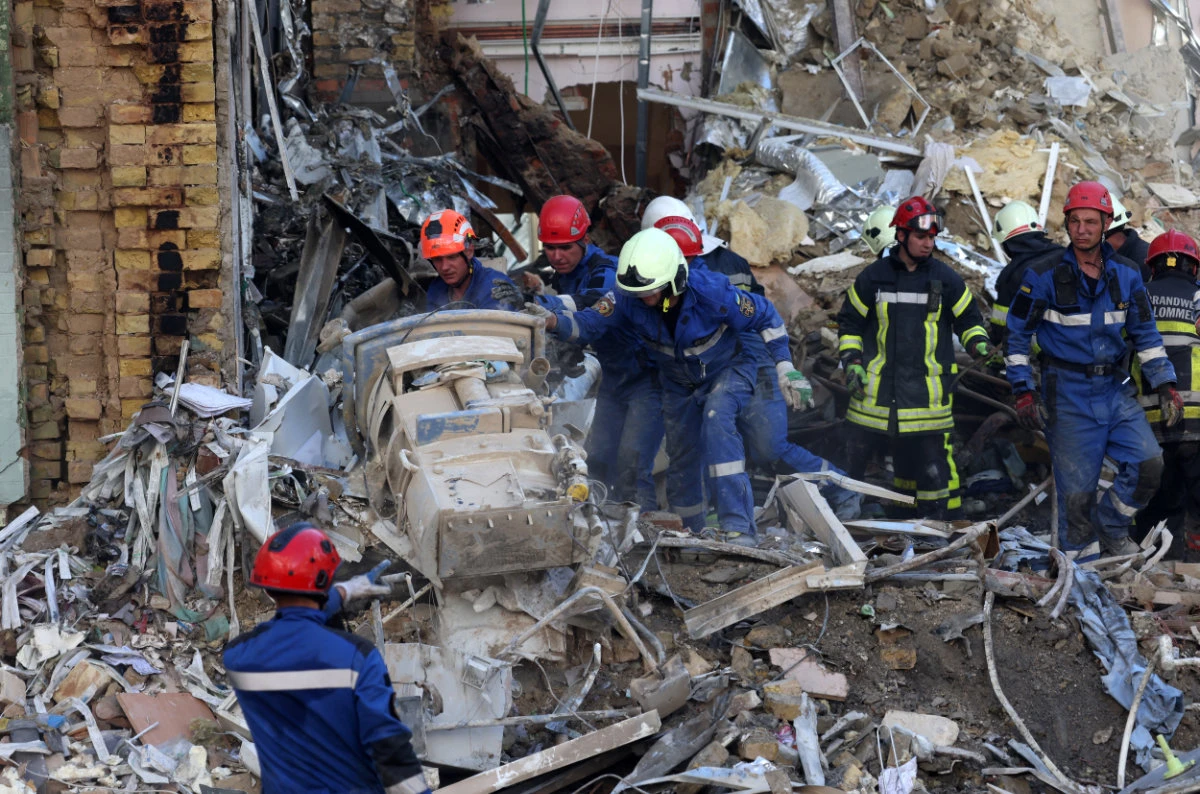 Emergency and rescue personnel operate and clear the rubble of the destroyed building of Ohmatdyt Children's Hospital, a day after a Russian missile attack in Kyiv on July 9, 2024. (AFP)