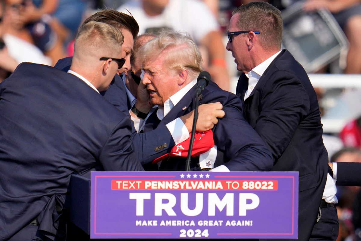 Republican presidential candidate former President Donald Trump is helped off the stage at a campaign event in Butler, Pennsylvania, on July 13, 2024. (AP/File)