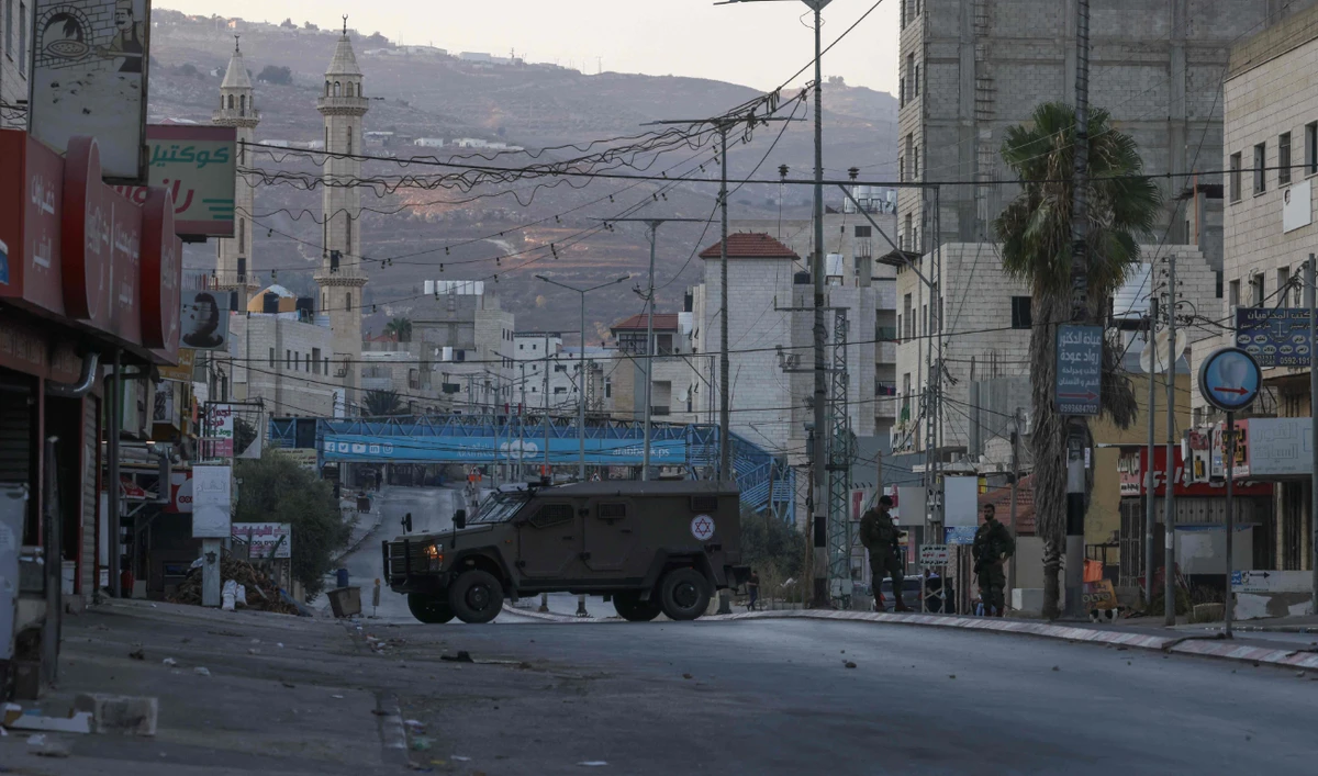 Israeli security forces close off a main entrance to Huwara town in the occupied West Bank following reported attacks by extremist settlers. (File/AFP)