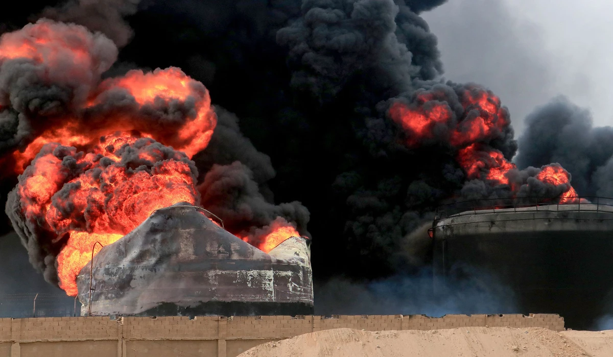 Thick smoke billows from a raging fire at oil storage tanks a day after Israeli strikes on the port of Yemen's Huthi-held city of Hodeida on July 21, 2024. (AFP)