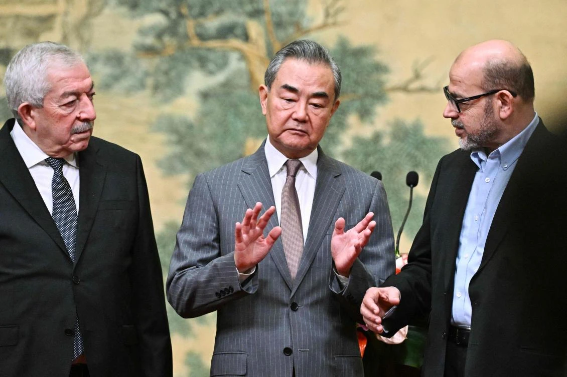From left: Mahmoud Al-Aloul, Vice Chairman of the Central Committee of Fatah, China’s Foreign Minister Wang Yi, and Mussa Abu Marzuk, senior member of Hamas, attend an event at the Diaoyutai State Guesthouse in Beijing on July 23, 2024. (AFP)