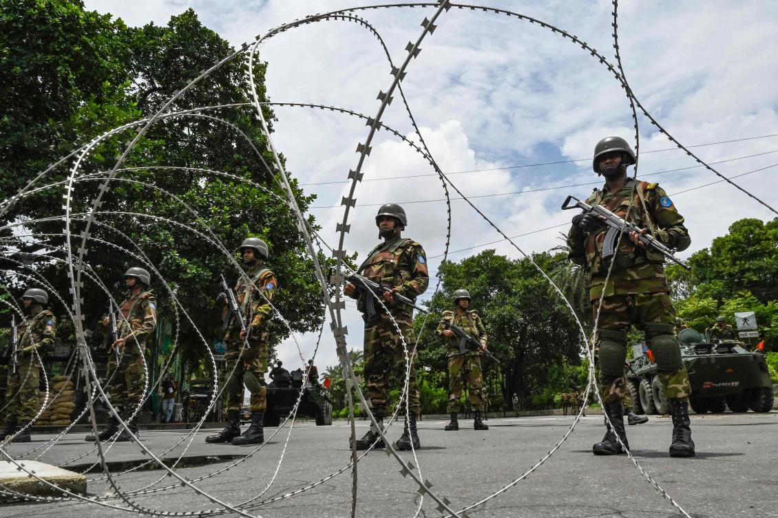 There is a heavy military presence in Dhaka, with bunkers set up at some intersections and key roads blocked with barbed wire after a curfew was imposed. (AFP)