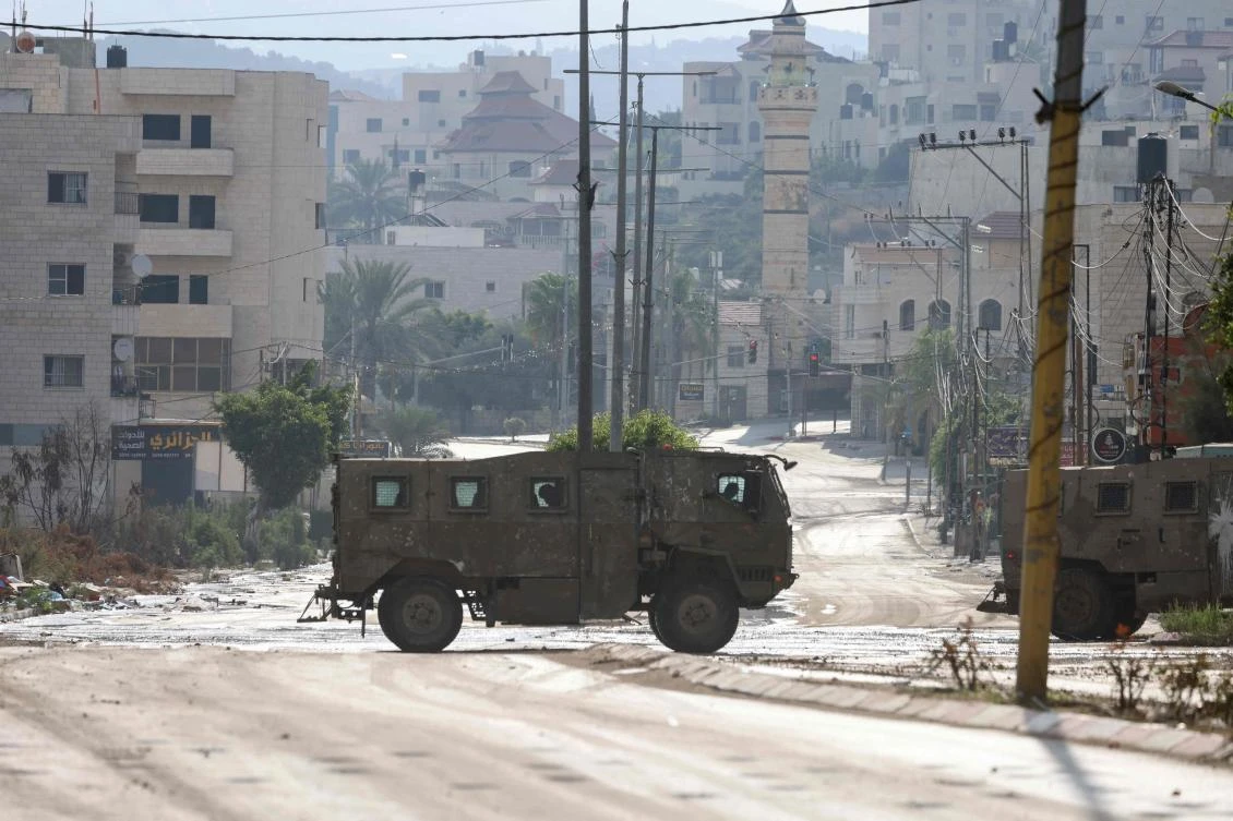 An Israeli army armoured vehicle drives during a raid in the Tulkarem camp for Palestinian refugees in the occupied West Bank on July 23, 2024. (AFP)