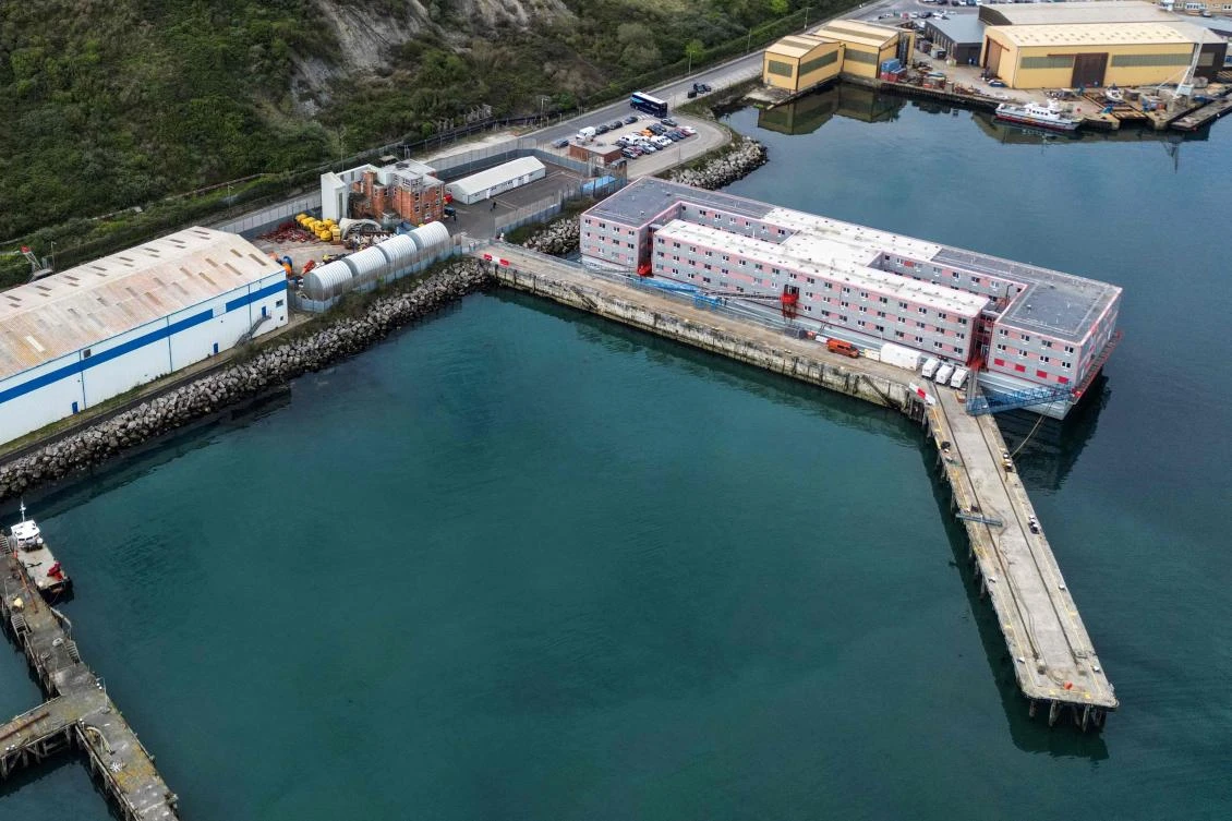 An aerial photograph taken on April 24, 2024 shows the Bibby Stockholm accommodation barge, moored to the quayside at Portland Port, in Portland, on the south-west coast of England. (AFP)