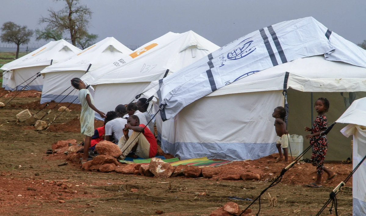 Displaced people gather outside their tent in a recently set up camp for internally displaced Sudanese from Sennar state, in the Al-Huri district of Gedaref city in the east of war-torn Sudan on July 14, 2024. (AFP)