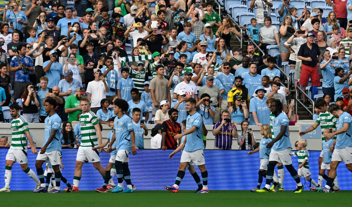 Players walk out on the pitch for the 2024 FC Series pre-season friendly football match between Manchester City and Celtic at the Kenan Memorial Stadium in Chapel Hill, North Carolina, July 23, 2024. (AFP)