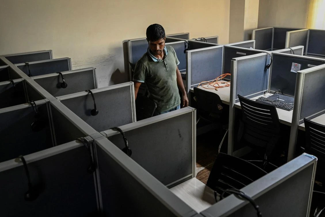 Above, a man cleans a desk at an empty call center in Dhaka following a nationwide curfew and internet shutdown imposed by the Bangladesh government. (AFP)