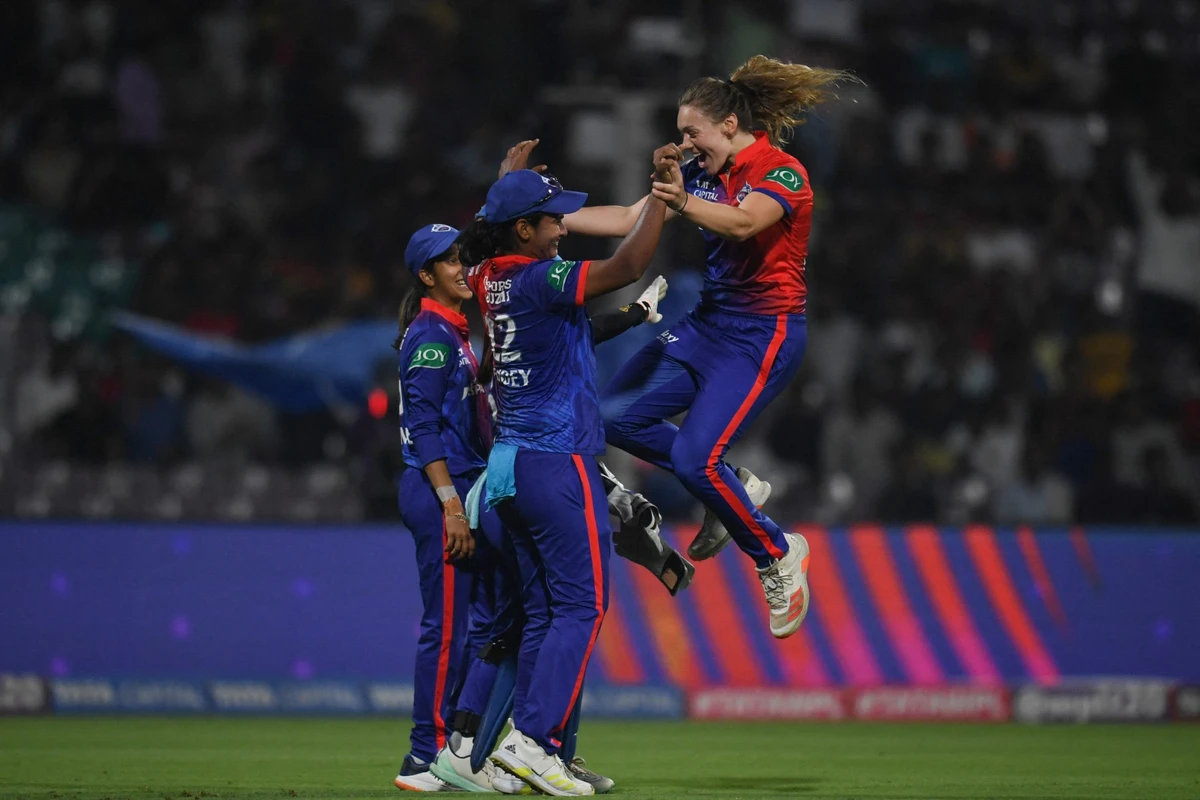 Delhi Capitals' Tara Norris (R) celebrates with teammates after the dismissal of Royal Challengers Bangalore's Heather Knight during the 2023 Women's Premier League (WPL) Twenty20 cricket match (AFP)