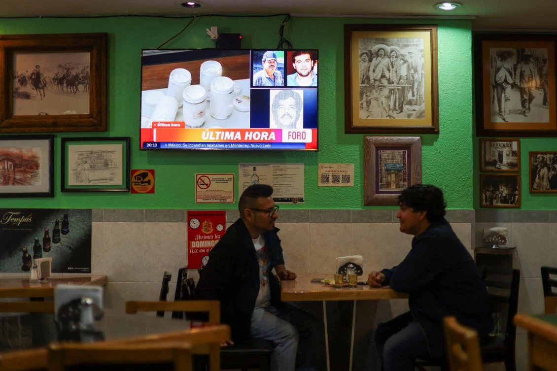 A news program announces arrest of Mexican drug lord Ismael Zambada and the son of his former partner, Joaquin Guzman, a canteen in Mexico City on 25, 2024. (Reuters)