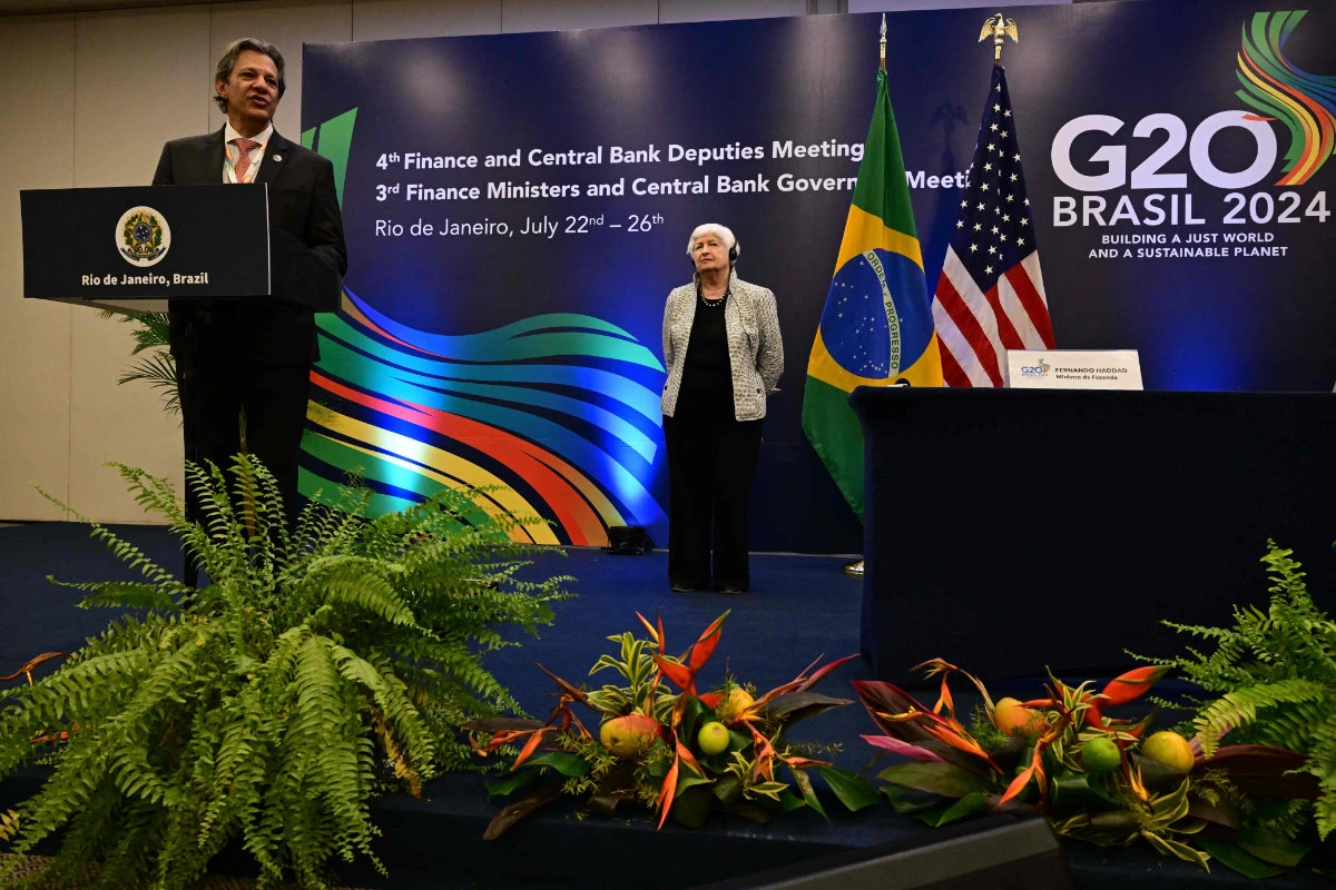 Brazil's Economy Minister Fernando Haddad (L) speaks next to US Treasury Secretary Janet Yellen after signing an agreement during the G20 economic ministers' meeting in Rio de Janeiro on July 26, 2024. (AFP)