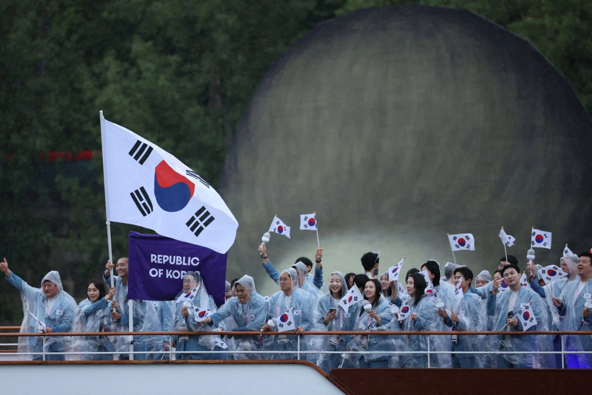 Athletes of South Korea aboard a boat in the floating parade on the river Seine during the opening ceremony of the 2024 Summer Olympics on July 26, 2024. (REUTERS)