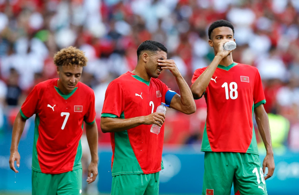 Morocco players react after they were caught by a 98th-minute sucker punch against Ukraine in the Olympics football on Saturday. (Reuters)
