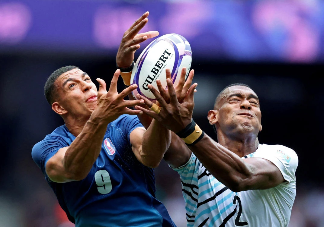 Aaron Grandidier Nkanang of France in action with Joseva Talacolo of Fiji at the Paris 2024 Olympics — Rugby Sevens — Men’s Pool C — at Stade de France, Saint-Denis, on July 25, 2024. (Reuters)