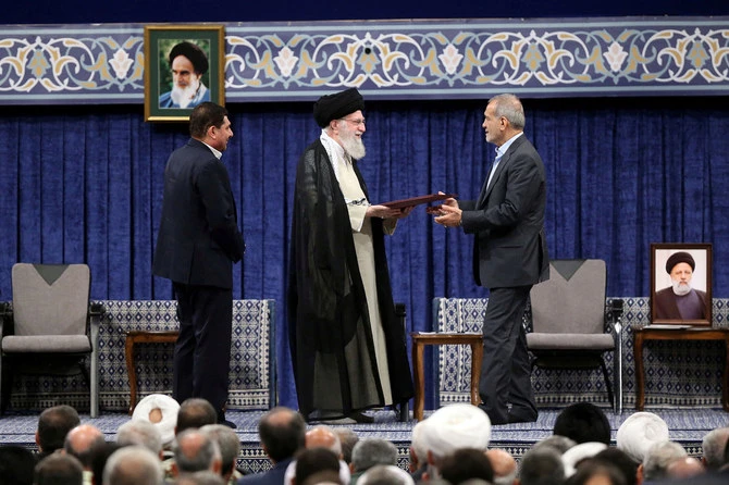 Iran's Supreme Leader Ayatollah Ali Khamenei gives a Presidential decree to Iran's new president, Masoud Pezeshkian, during an endorsement ceremony in Tehran, Iran, July 28, 2024. (Reuters)